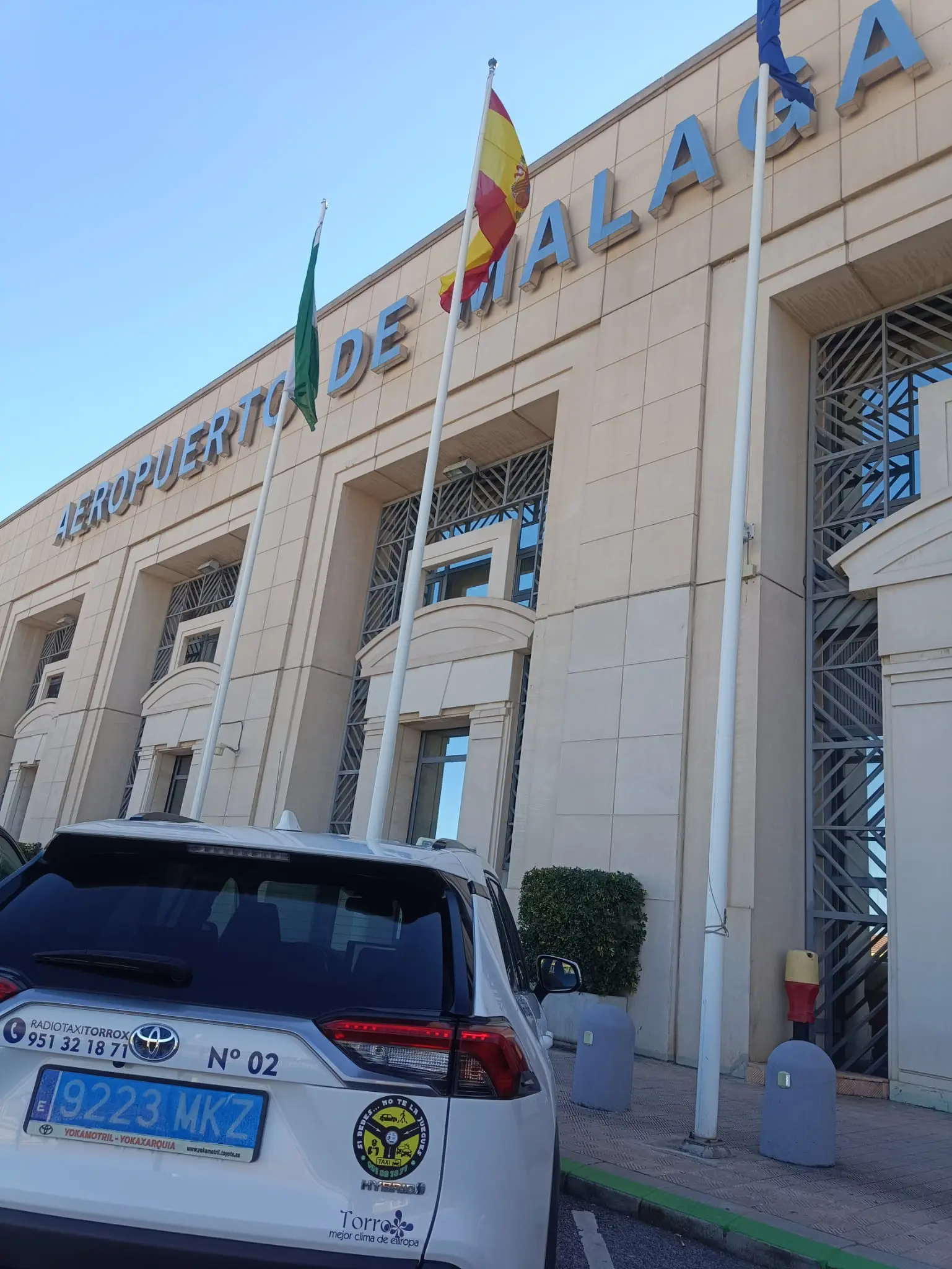 Torrox Taxi no. 02 parked in front of the Málaga Airport terminal